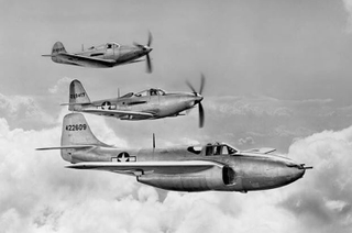 A Bell family photo: the first production P-59A flies in formation with a Bell P-63 King Cobra (center) and a Bell P-39 Airacobra (top). (US Air Force)